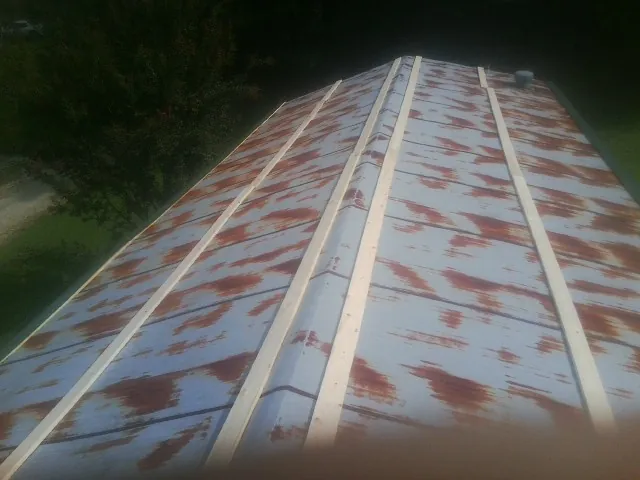 Rusted metal roof panels with new wood purlins before replacement — Storm Damage Roof Repair in Willows by Roofing Brothers