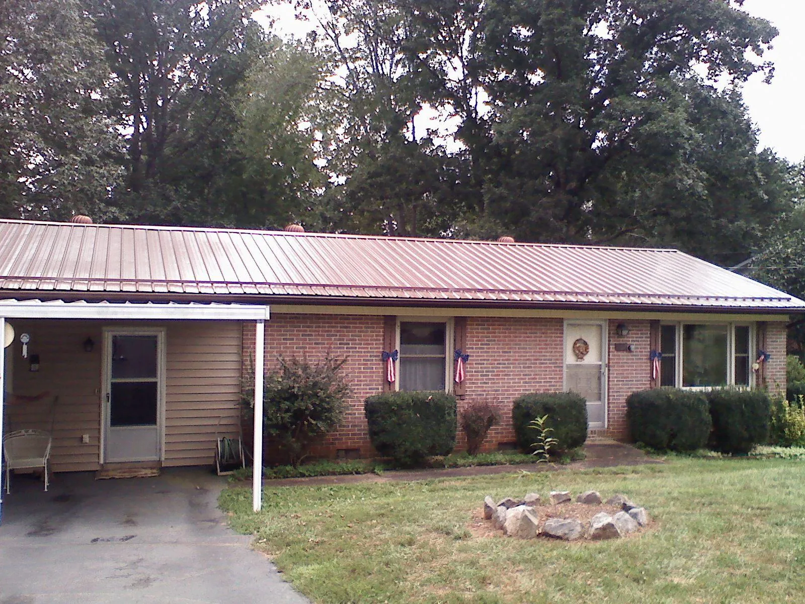 Bronze metal roof and carport on a brick ranch home — Roof Repair work by our crew in Willows
