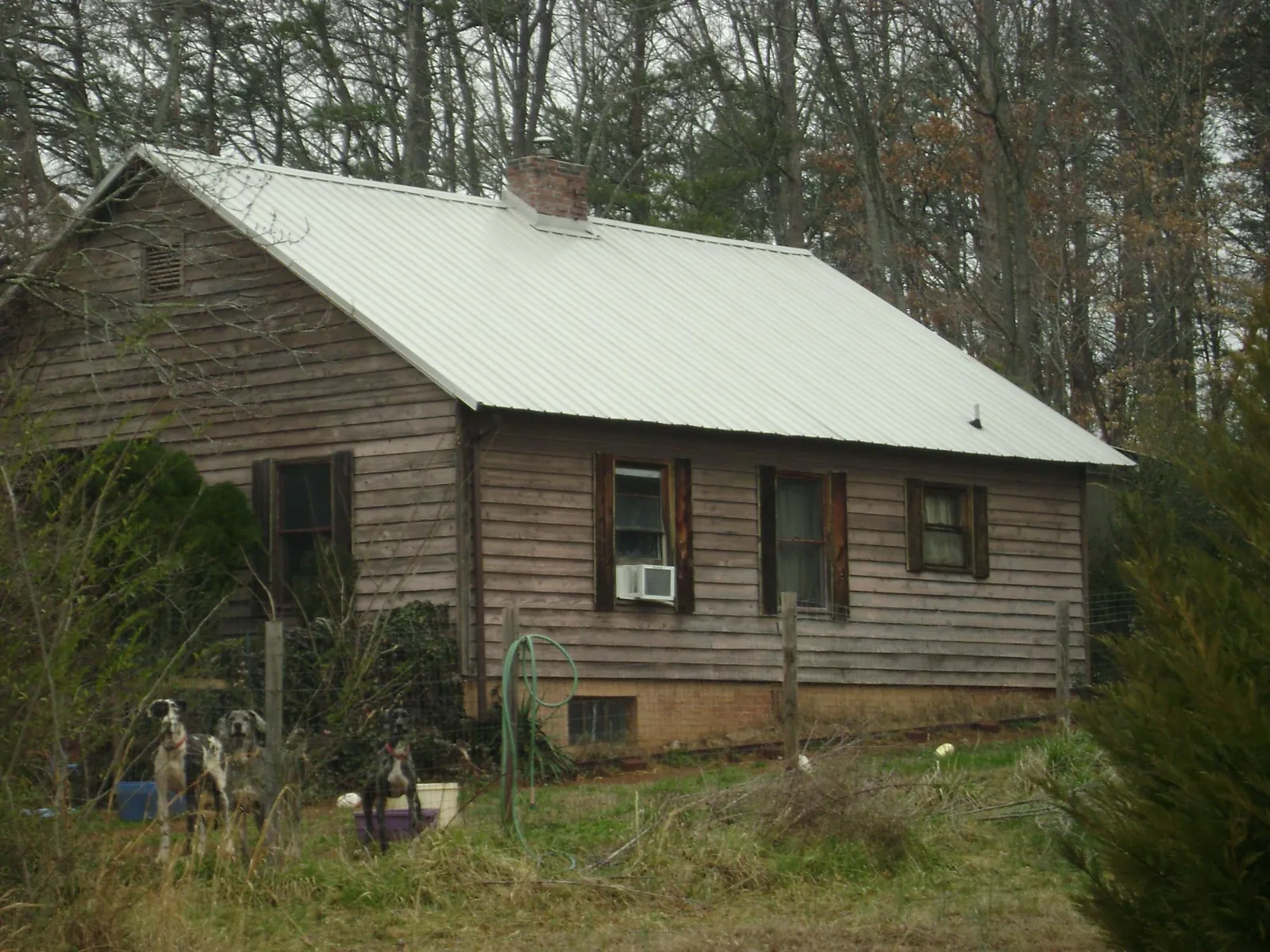 White metal roof on an old wood sided farmhouse, from a Metal Roof Installation job in Willows